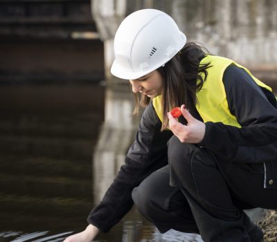 environmental-engineer-getting-water-sample-full-shot